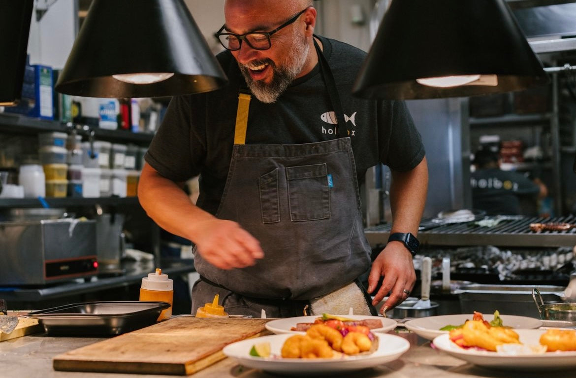 Chef Gilberto Cetina Jr. in his Holbox kitchen wearing a BlueCut apron