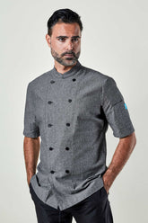 Man wearing a charcoal chambray double-breasted chef coat.