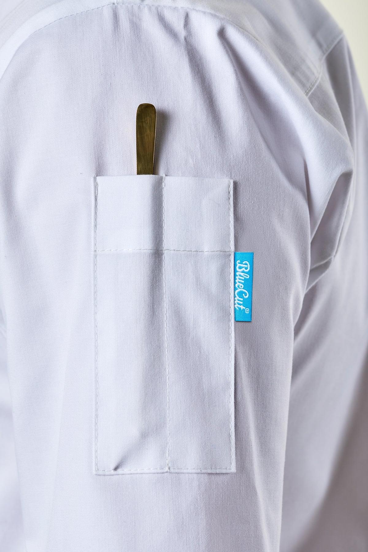 Close-up of the pen and thermometer pocket on a white chef coat.