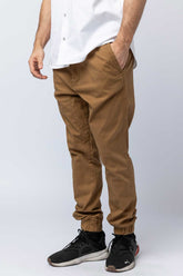 Close-up of a man in khaki joggers.