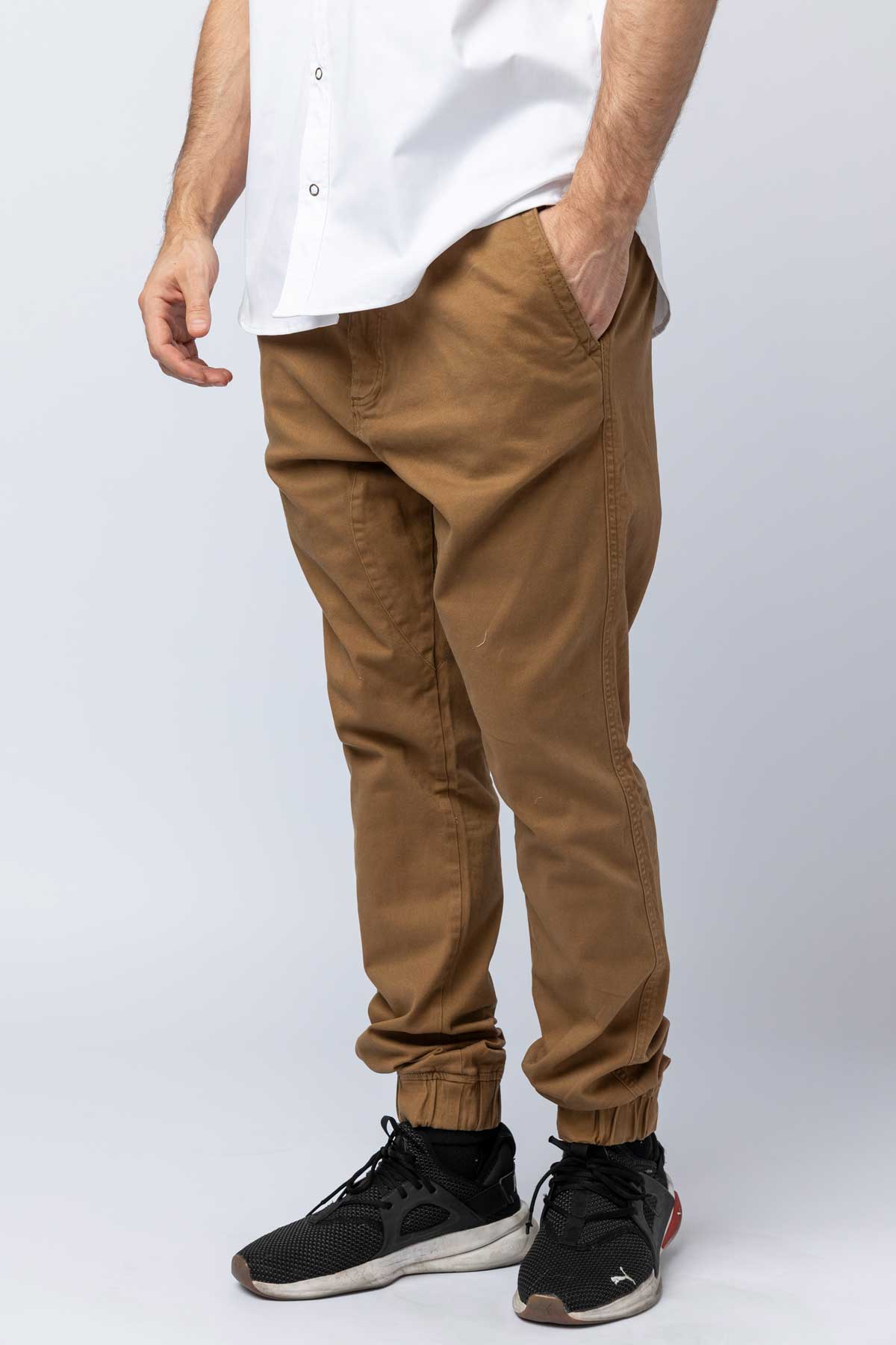 Close-up of a man in khaki joggers.
