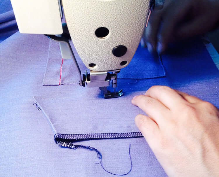Image of person sewing chef apron. | BlueCut Aprons 