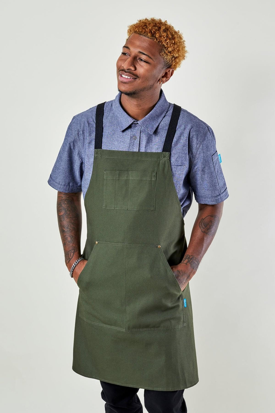 Image of person wearing Dover Cross Back Apron in Olive Canvas. | BlueCut Aprons