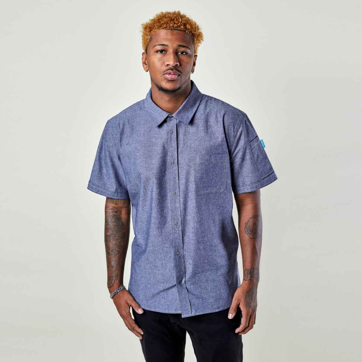 Image of person wearing Logan Chambray shirt in blue. | BlueCut Aprons				