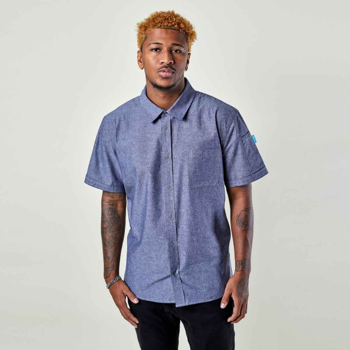 Image of person wearing Logan Chambray shirt in blue. | BlueCut Aprons