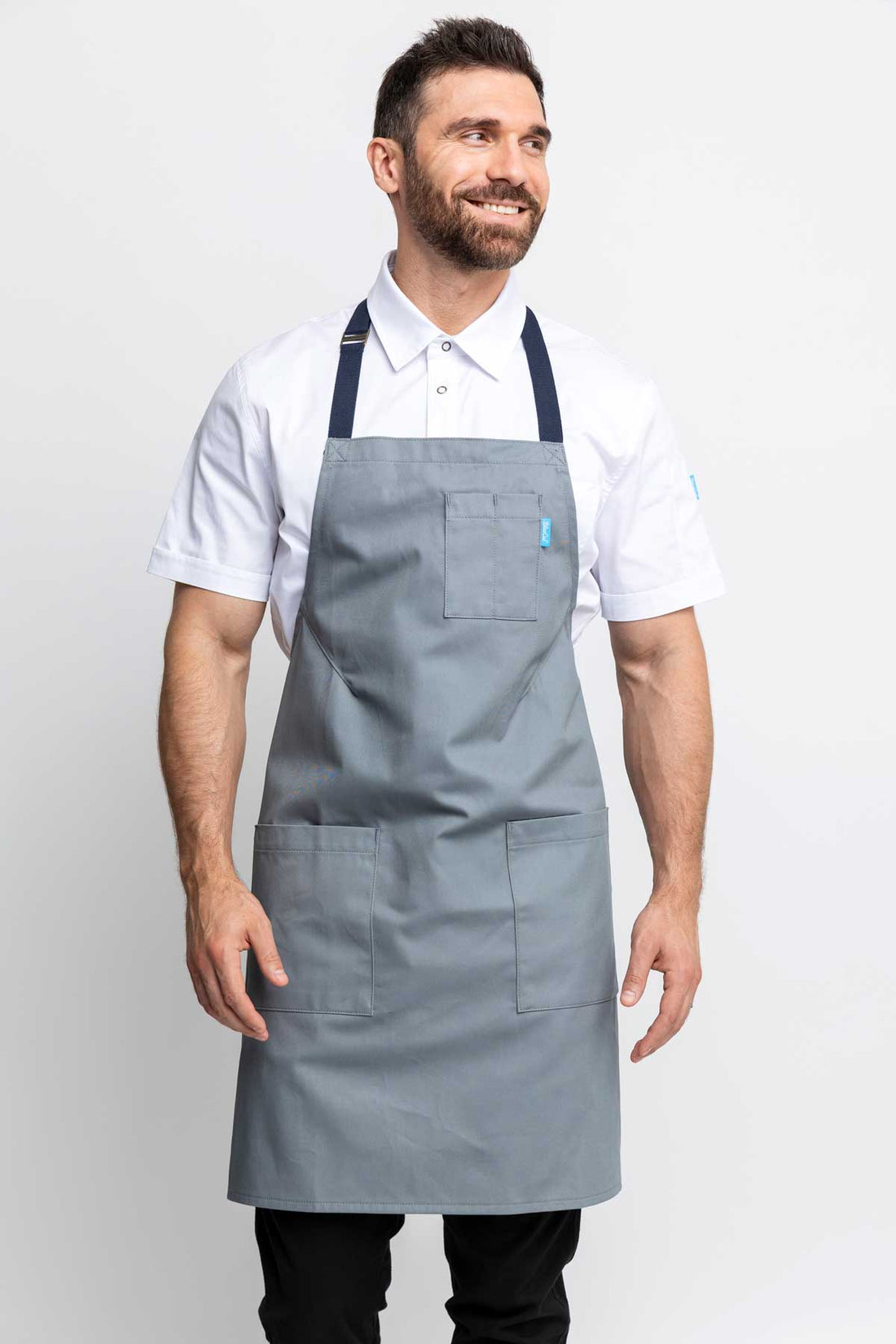 Front view of a man wearing an silver grey-colored denim apron