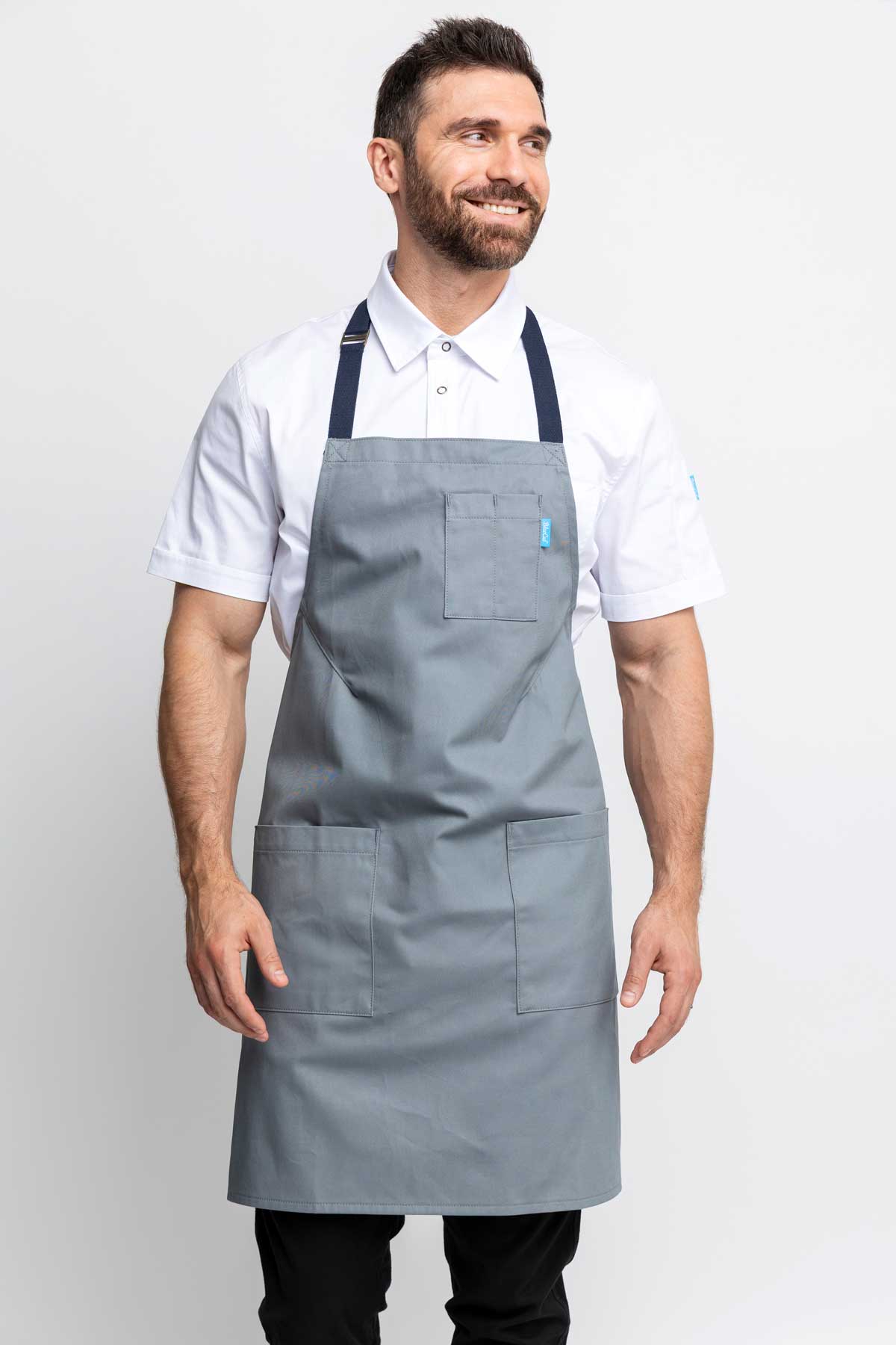 Front view of a man wearing an silver grey-colored denim apron