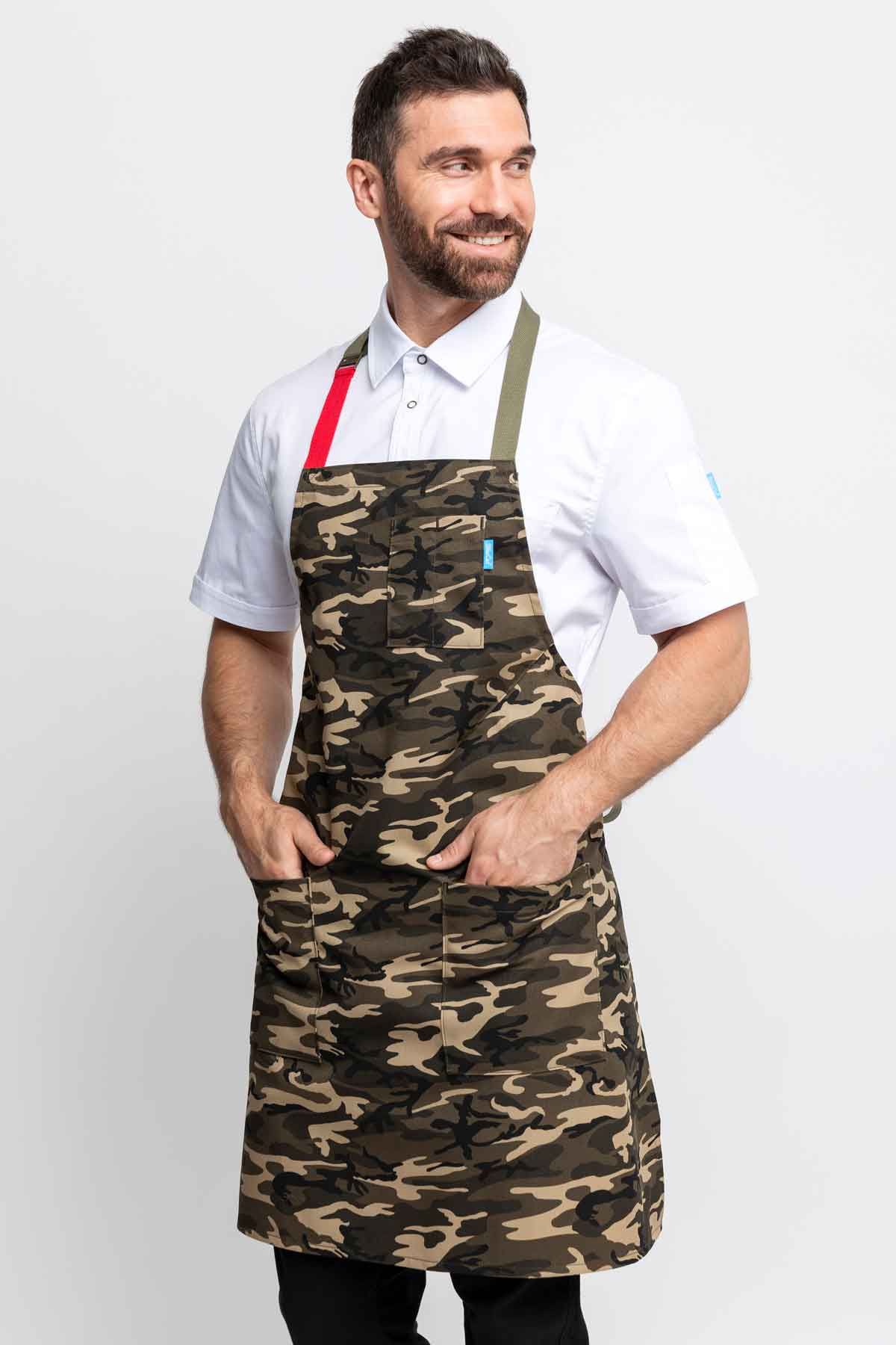 Three quarter view of a man wearing a camo apron.