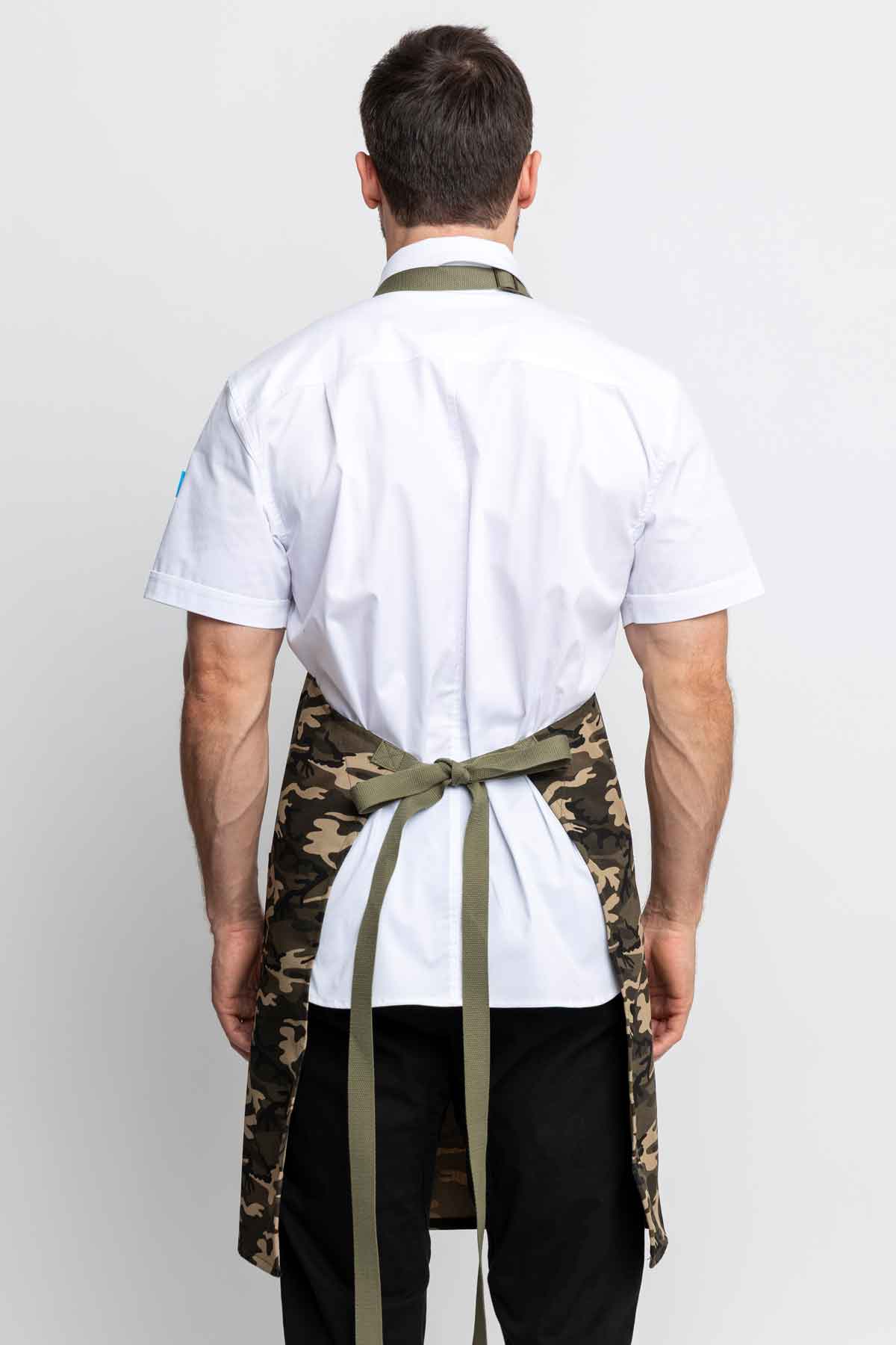 Back view of a man wearing a camo apron.