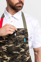 Close-up of a man wearing a camo apron, placing a pen in the chest pocket.