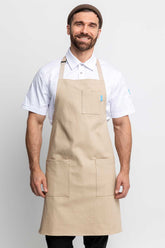 Front view of a man wearing an oatmeal-colored denim apron