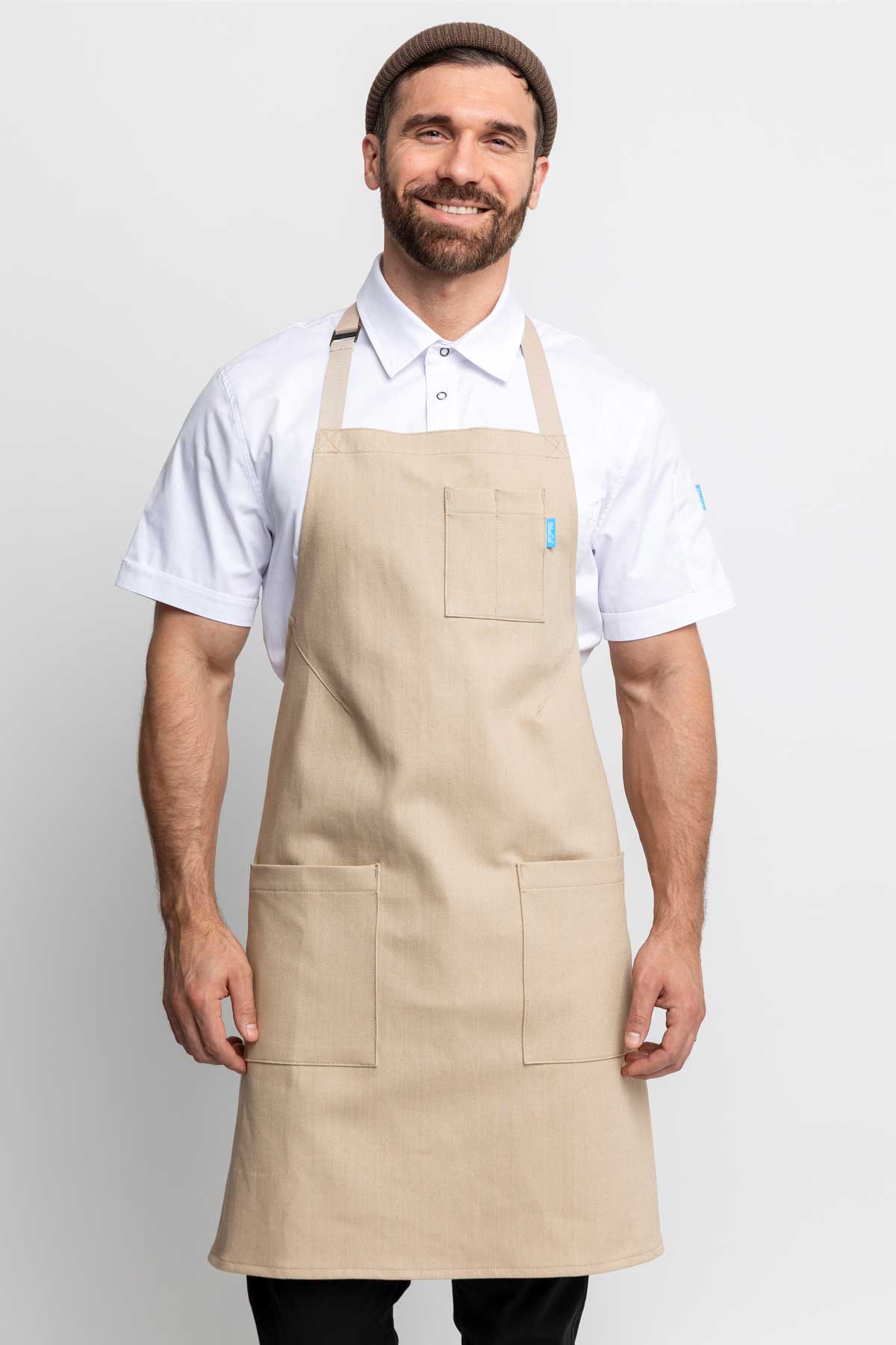Front view of a man wearing an oatmeal-colored denim apron