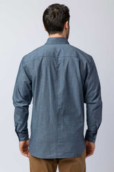 Rear view of men wearing blue long-sleeve chambray button-down shirts.