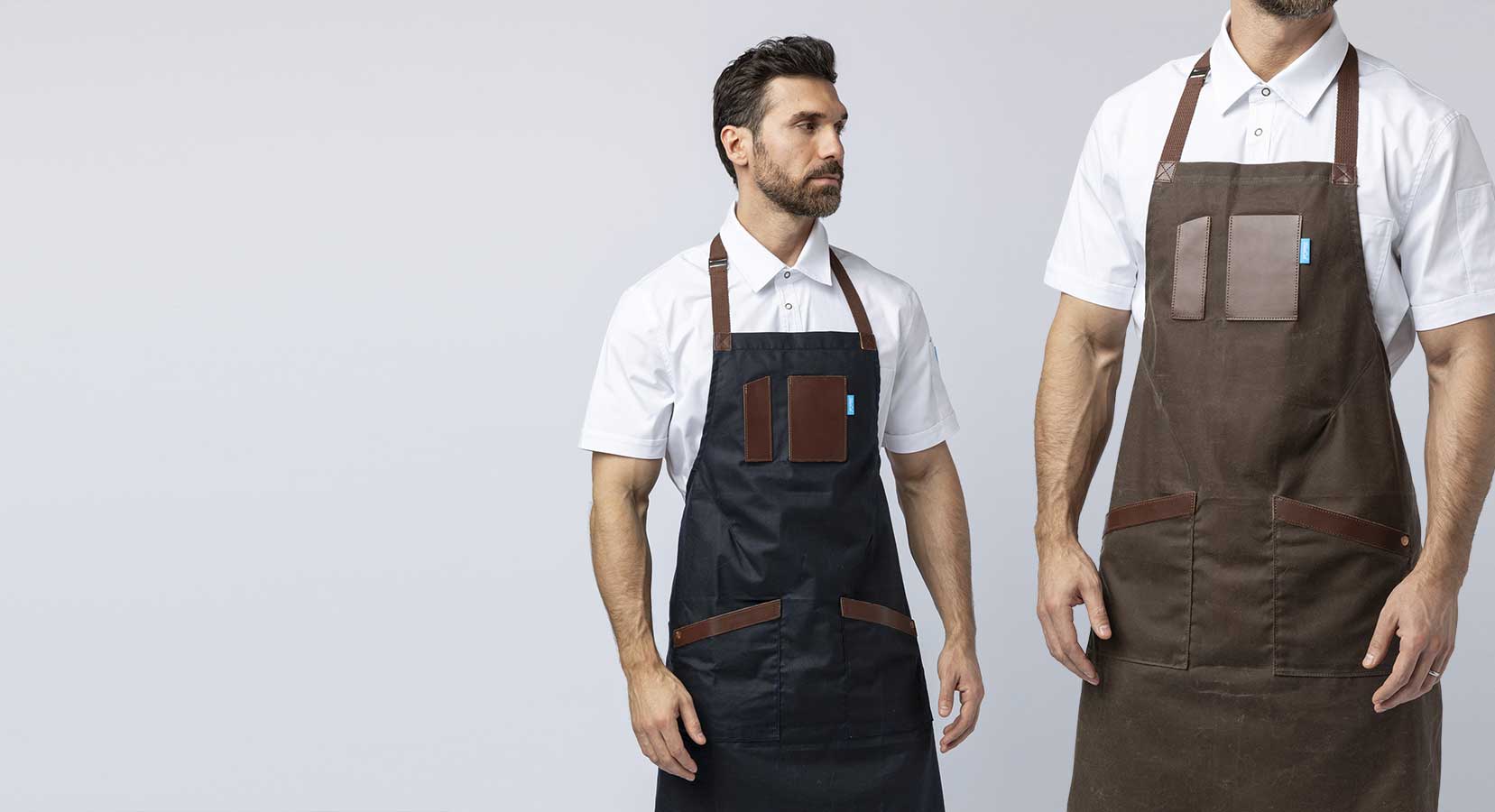 Men wearing navy blue and brown aprons with leather details.