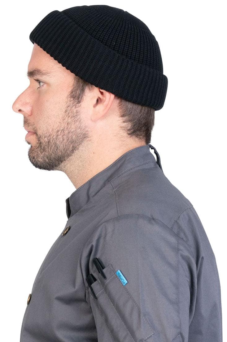 Profile close-up of a man wearing a black beanie.