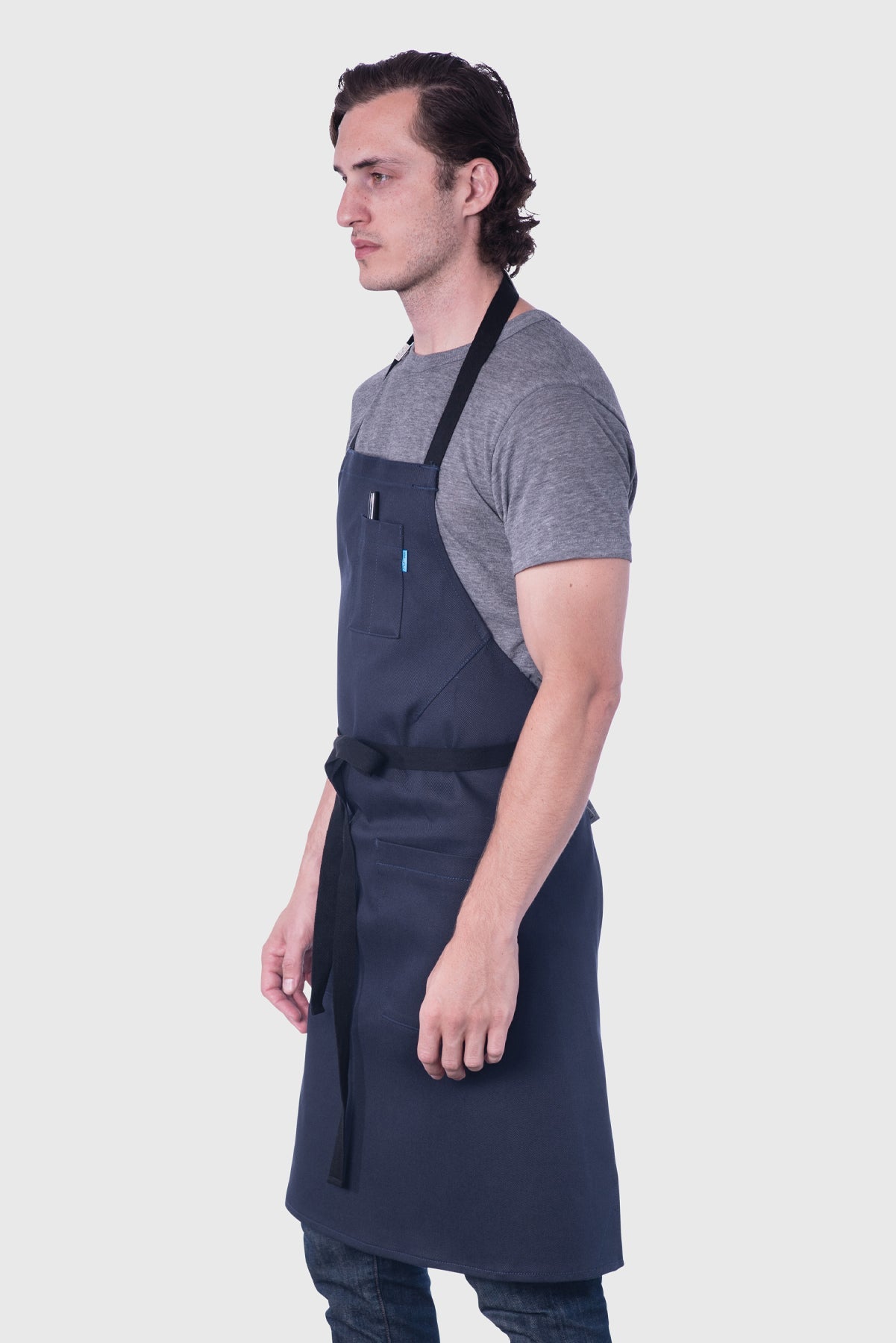 Side view image of person wearing Line Apron in Navy Poly Cotton Twill. | BlueCut Aprons