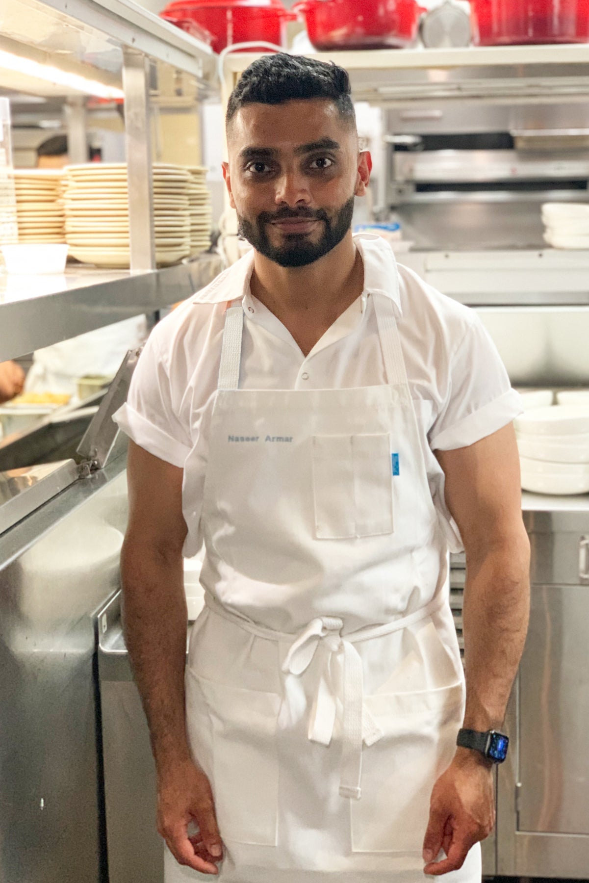 Image of person wearing Line Apron in White Cotton Twill in kitchen. | BlueCut Aprons