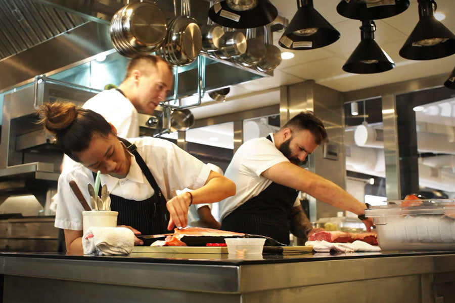 Image of chefs cooking in industrial kitchen