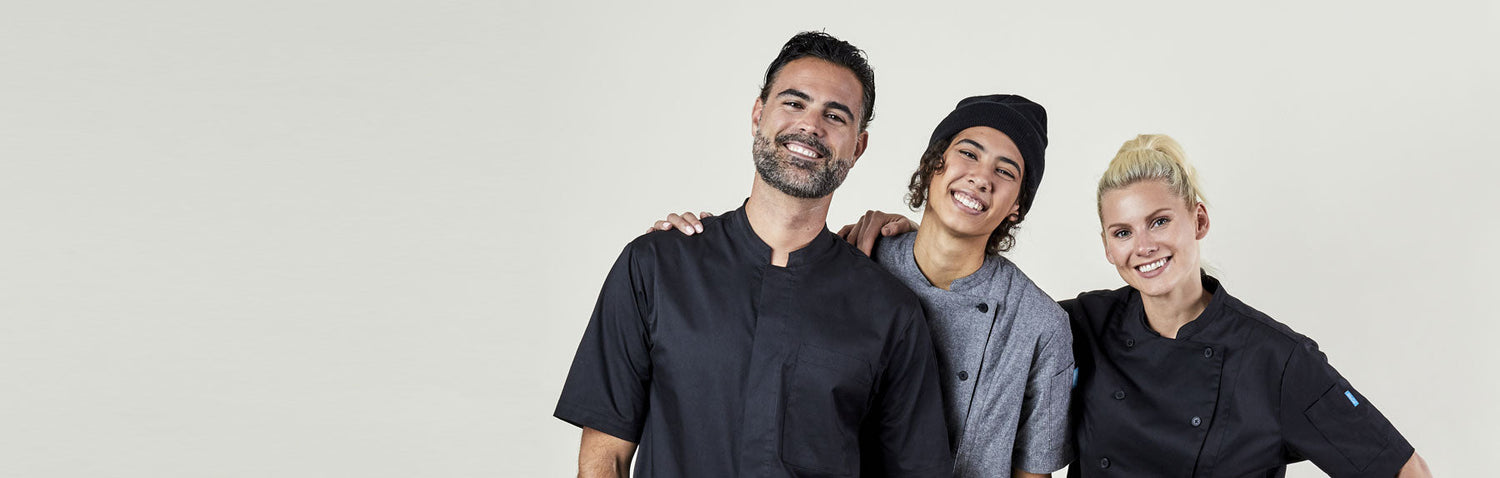Image of people wearing black and chambray chef coats. | BlueCut Aprons		