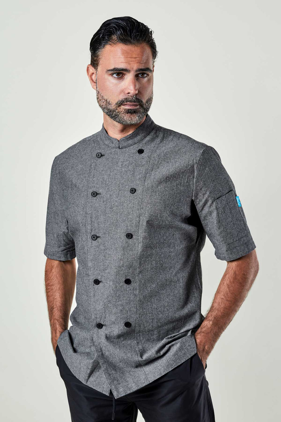 Man wearing a charcoal chambray double-breasted chef coat.