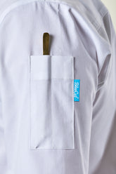 White chef coat with a  pen pocket and a BlueCut label on a light background