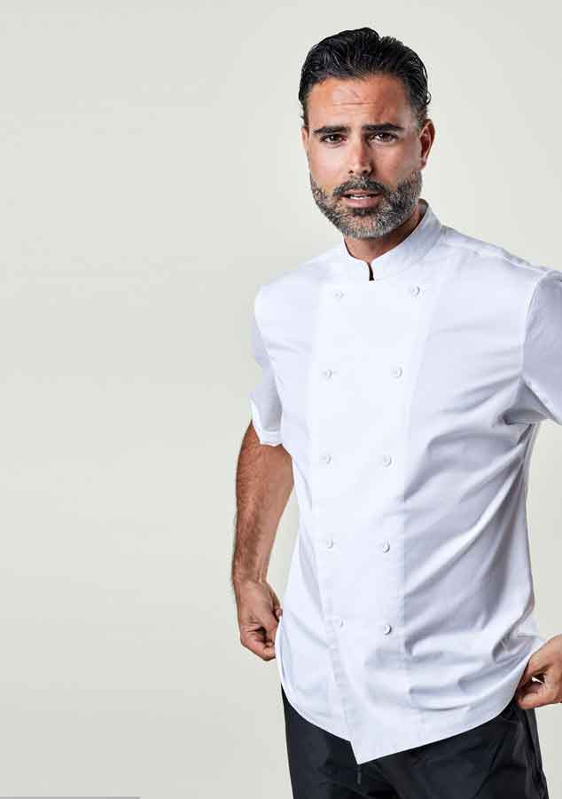 Man wearing a white chef's coat against a plain background