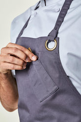 Close up image of person wearing Belfast Apron in Grey Twill. | BlueCut Aprons				