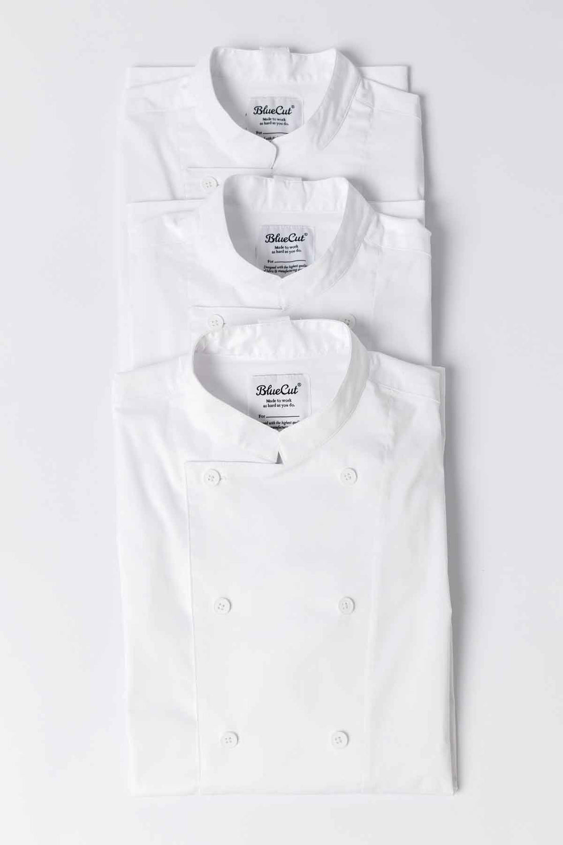Stack of Ambassador chef coats in white