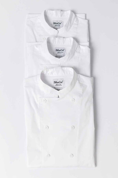 Stack of Ambassador chef coats in white