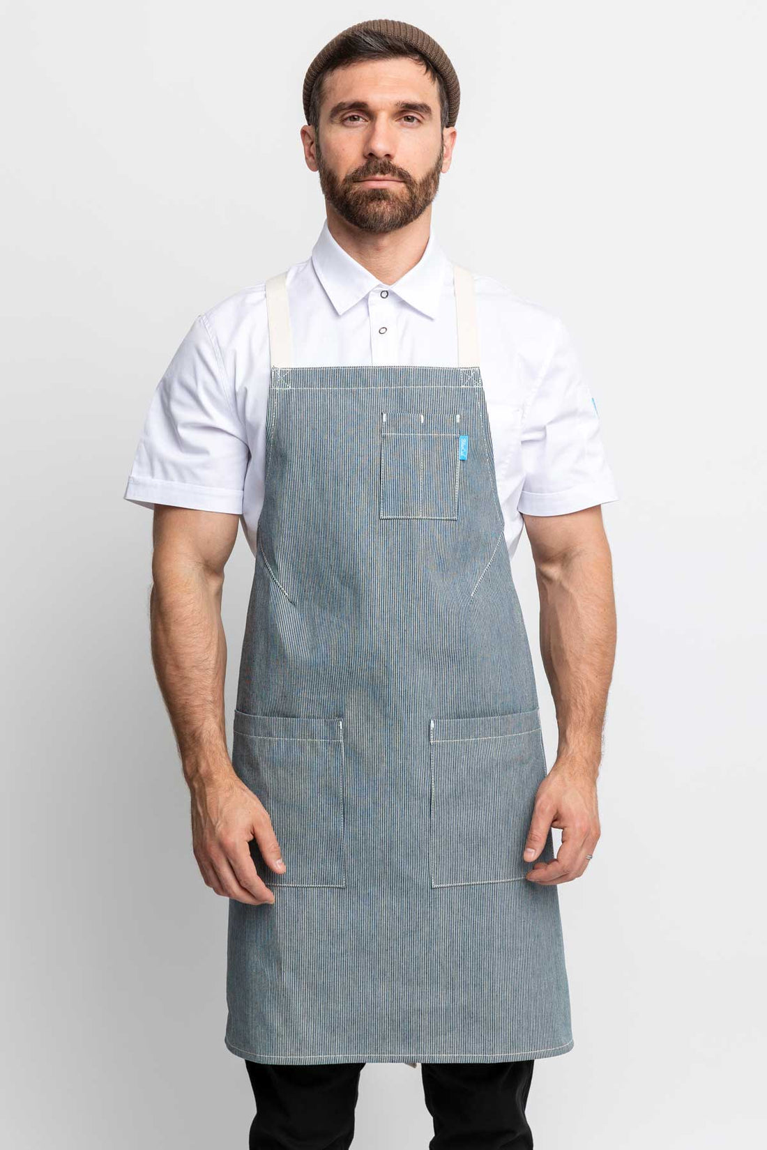 Front view of a man wearing an railroad stripe denim apron
