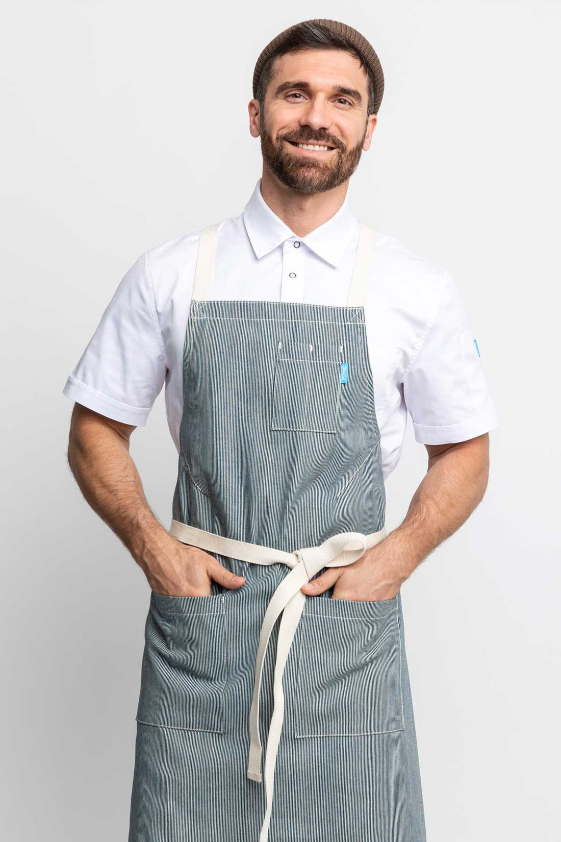 Front view of a man wearing an railroad stripe denim apron