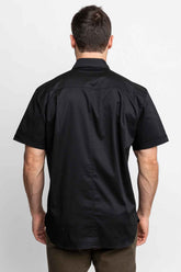 Back view of men wearing black short-sleeve button-down shirts.