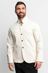 Front view of a man wearing a fully buttoned natural-colored task jacket.