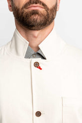 Detail view of a man wearing a task jacket in natural color.