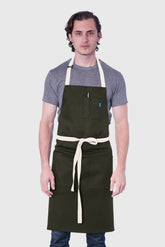 Image of person wearing Line Apron in Olive Cotton Twill. | BlueCut Aprons