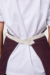 Back view image of person wearing Line Apron in Wine Cotton Twill. | BlueCut Aprons