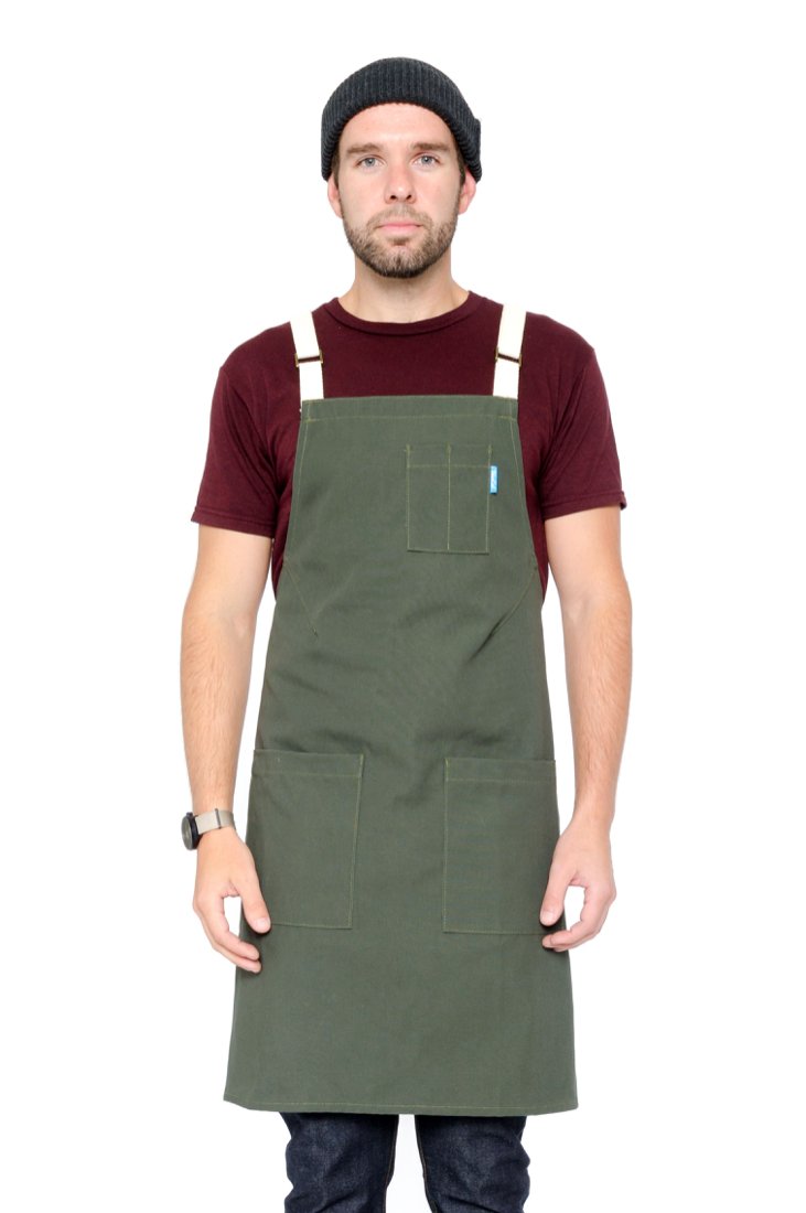 Image of person wearing Lucca Crossback Apron in Olive Canvas. | BlueCut Aprons				
