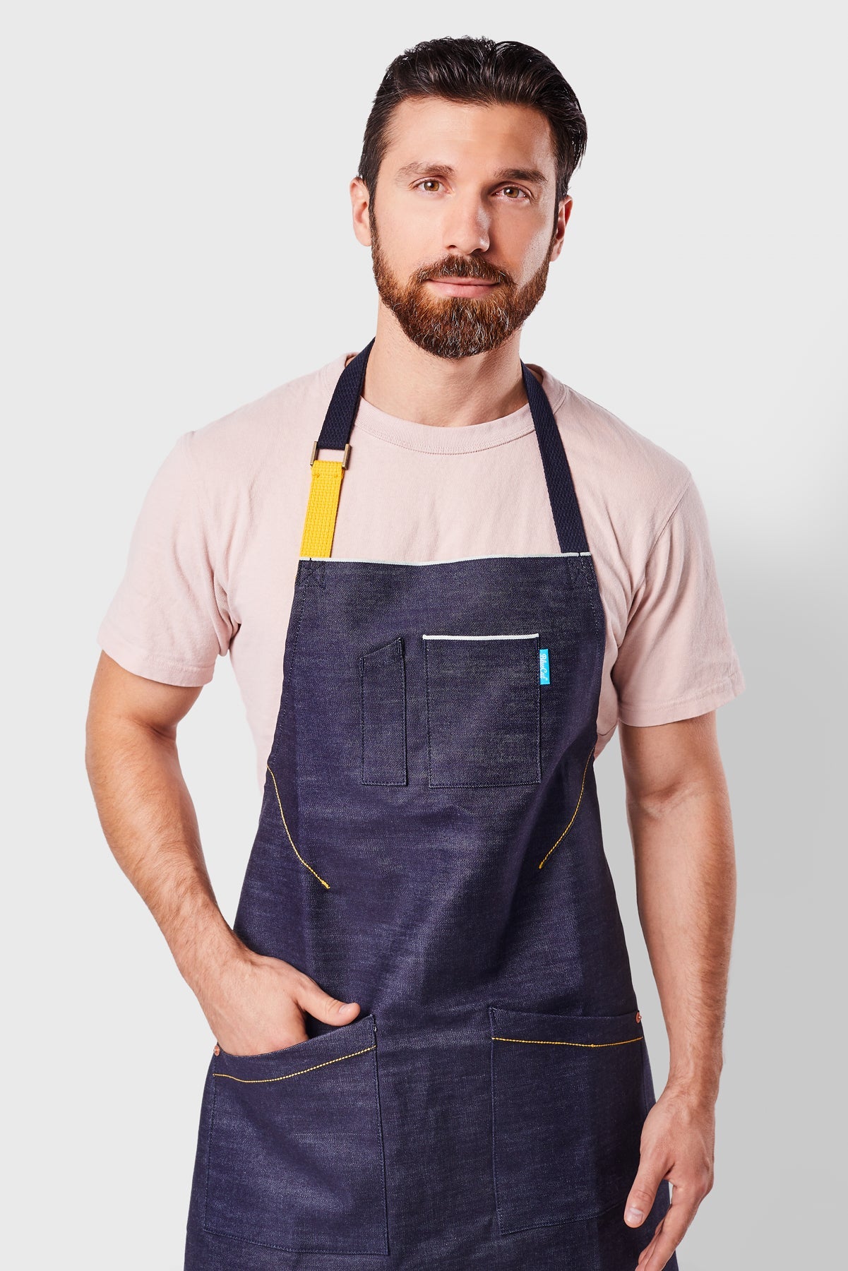 Close up image of person wearing Mason Apron in Indigo Selvage Denim. | BlueCut Aprons